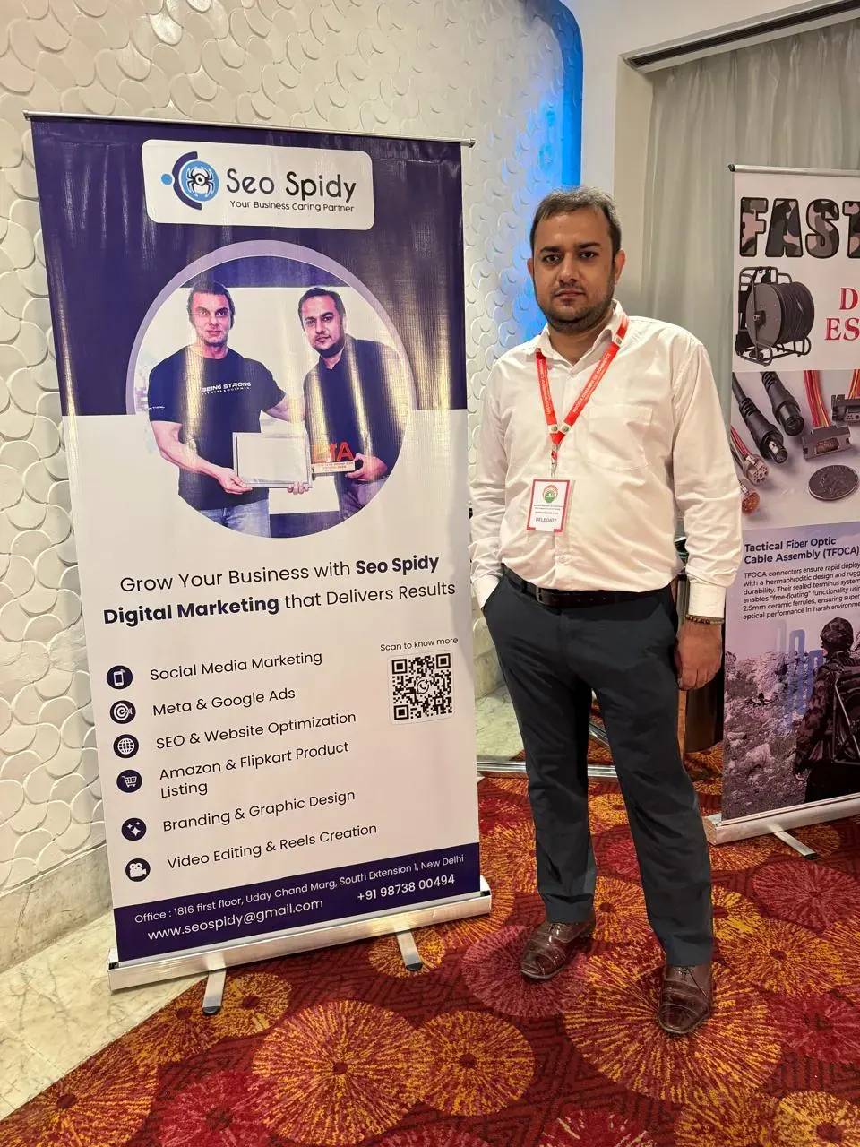 Rahul Sharma, founder of Seospidy, beside the Seospidy stand at an event